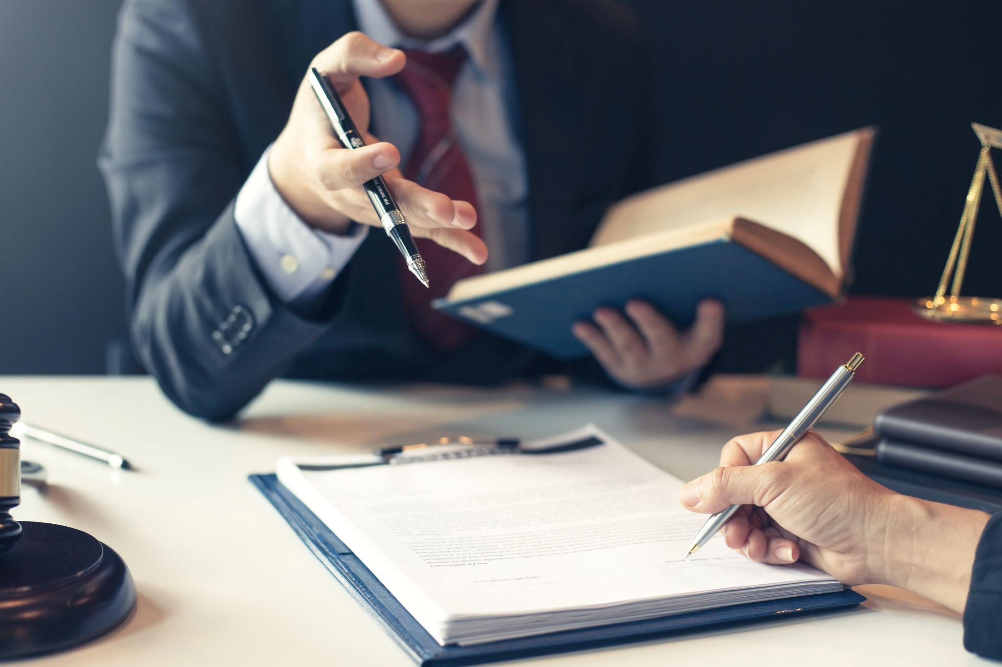 Businessman and lawyer discuss the contract document